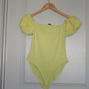 Yellow blouse that is tight on body